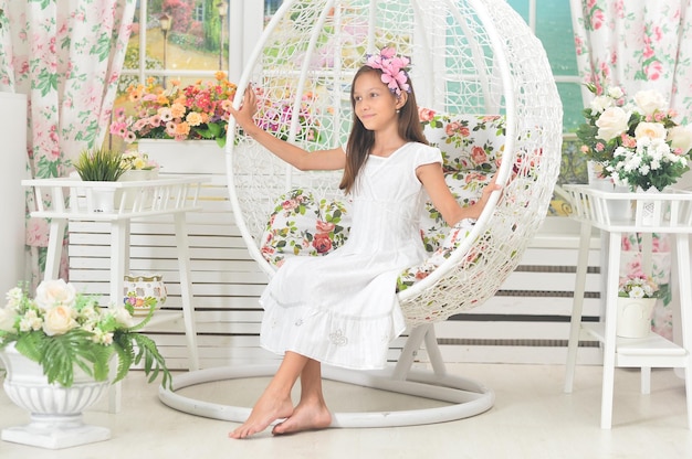 Emotional little girl in a white dress posing