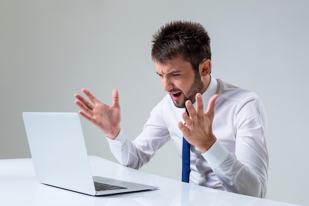 Emotional man and laptop