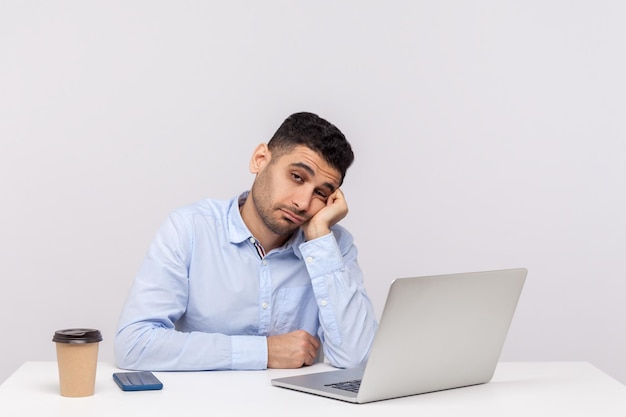 Emotional man sitting and working on office