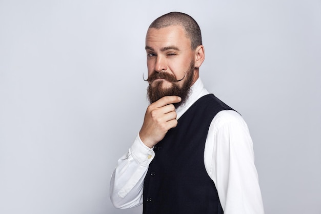 Emotional man in suit on gray background