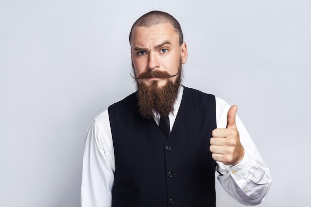 Emotional man in suit on gray background