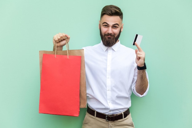 Emotional man in white shirt near green background