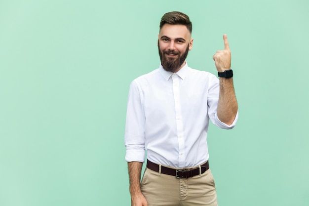 Emotional man in white shirt near green background