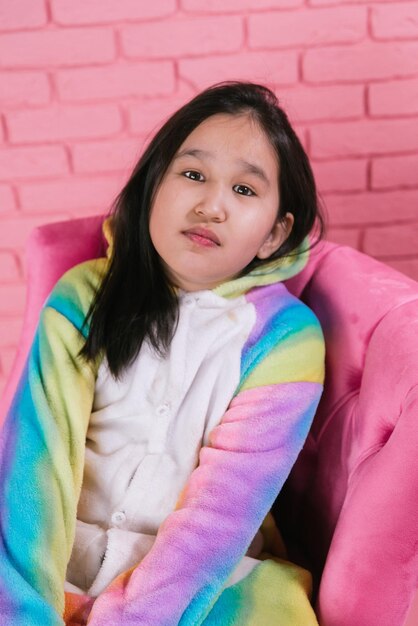 emotional portrait of asian girl in halloween costumes on pink background