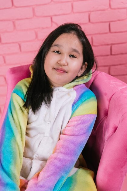 emotional portrait of asian girl in halloween costumes on pink background