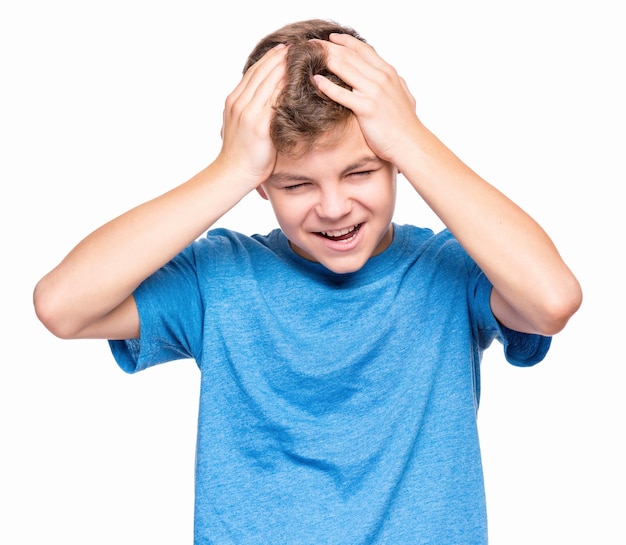 Emotional portrait of caucasian teen boy wearing blue tshirt Surprised or scared teenager Handsome child isolated on white background