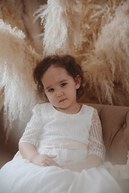 emotional portrait of little asian girl in a angel costume costumes vintage style