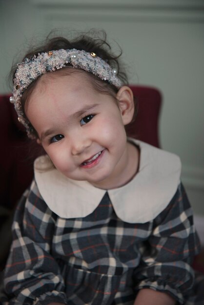 emotional portrait of little asian girl in a vintage dress halloween vintage style