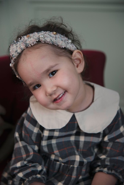 emotional portrait of little asian girl in a vintage dress halloween vintage style