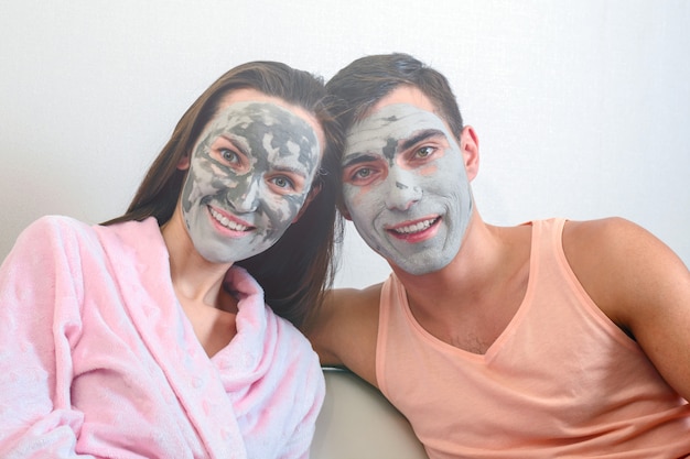 Emotional portrait of a married couple in masks made of clay. day Spa, Wellness, skincare