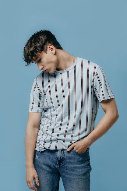 Emotional portrait of a young man on a blue background