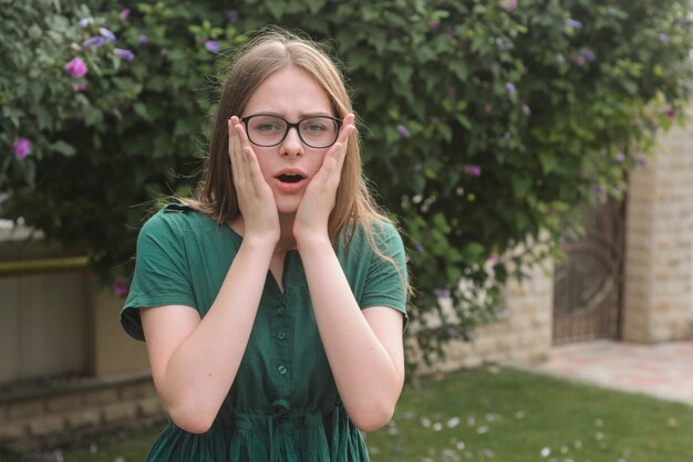 Emotional surpirized teen age girl, in green dress