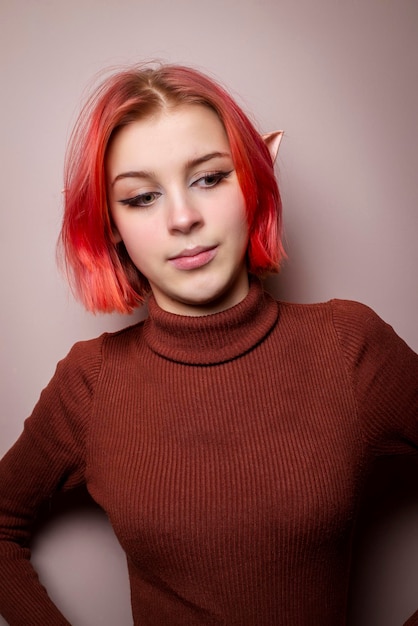 Emotional teenage girl with pink hair and elf ears