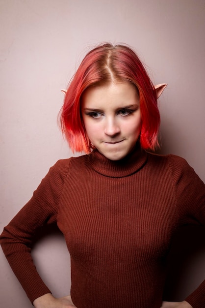 Emotional teenage girl with pink hair and elf ears