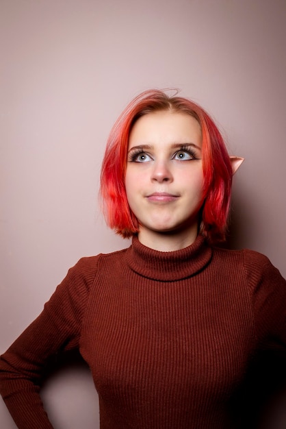 Emotional teenage girl with pink hair and elf ears