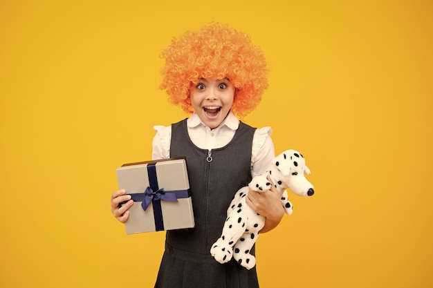 Emotional teenager child hold gift on birthday funny kid girl holding gift boxes celebrating happy new year or christmas excited face cheerful emotions of teenager girl