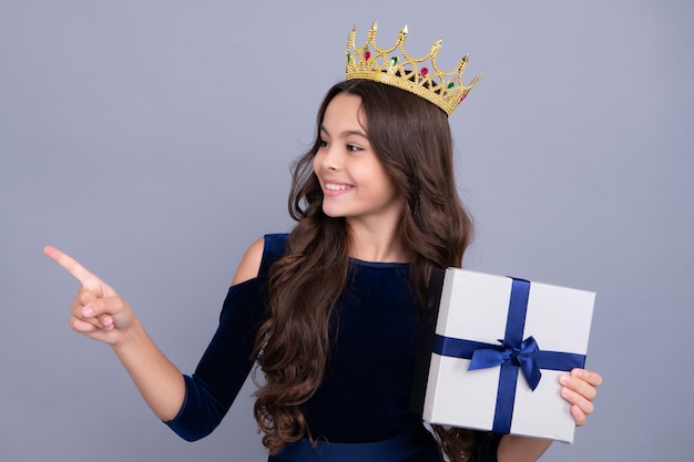 Emotional teenager child hold gift on birthday funny kid girl\
holding gift boxes celebrating happy new year or christmas happy\
face positive and smiling emotions of teenager girl