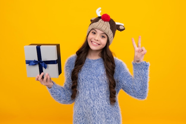 Emotional teenager child hold gift on birthday funny kid girl\
holding gift boxes celebrating happy new year or christmas happy\
teenager positive and smiling emotions of teen girl