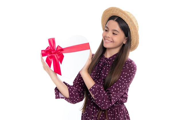 Emotional teenager child hold gift on birthday Funny kid girl holding gift boxes celebrating happy New Year or Christmas Portrait of happy smiling teenage child girl