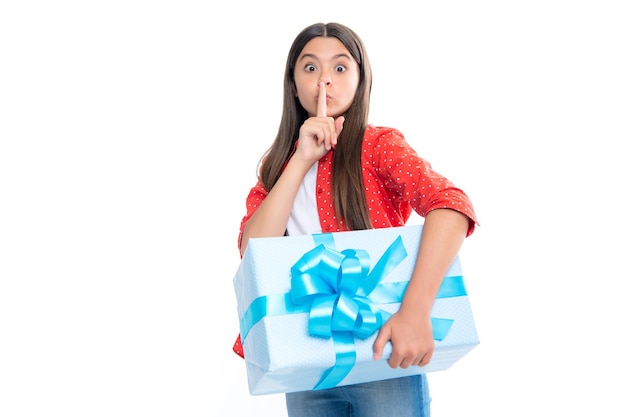 Emotional teenager child hold gift on birthday Funny kid girl holding gift boxes celebrating happy New Year or Christmas Serious teenager girl