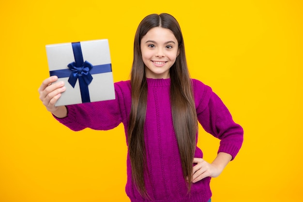 Emotional teenager child hold gift on birthday Funny kid girl holding gift boxes celebrating happy New Year or Christmas