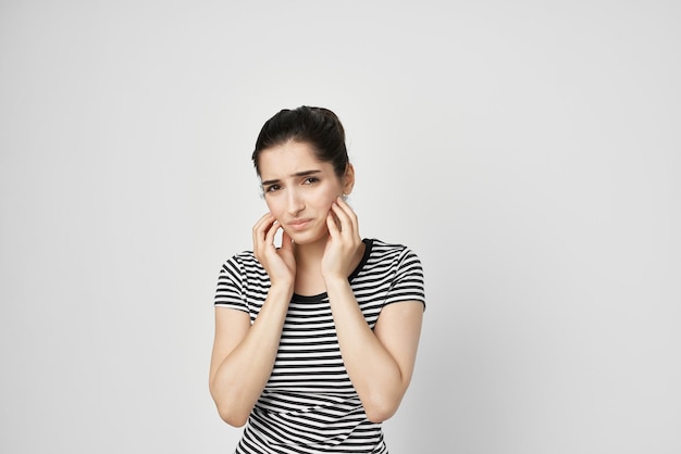 Emotional woman discomfort toothache dental treatment light background