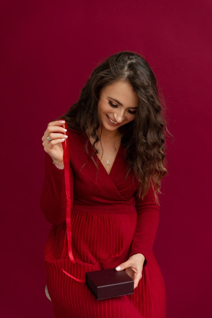 Emotional woman in red opened box with stripe and smiling