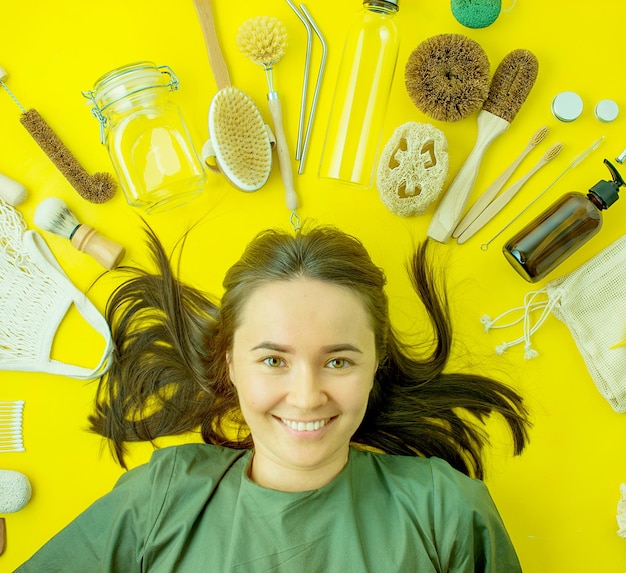 Emotional woman on yellow background with zero waste life kit