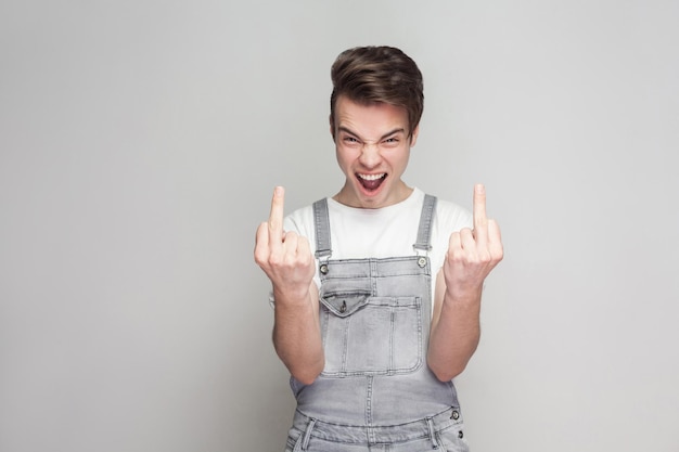 Emotional young man on gray background