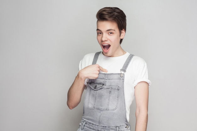 Emotional young man on gray background