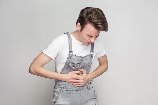 Emotional young man on gray background