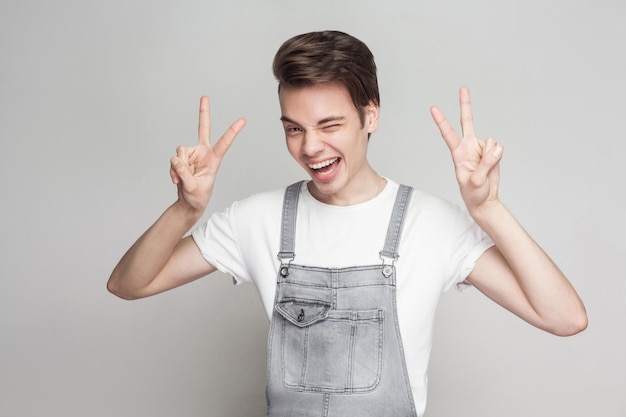 Emotional young man on gray background