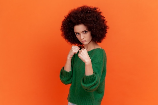 Emotional young woman on orange background