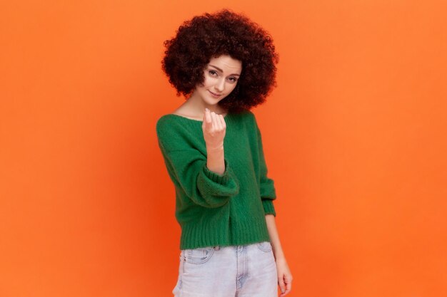 Emotional young woman on orange background