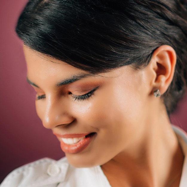 Emotions Love Face of a beautiful happy young woman in love studio portrait pink background