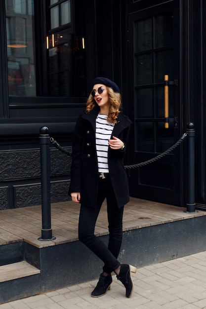 Emotions, people, beauty and lifestyle concept - Girl Frenchwoman. Street photo of young woman wearing stylish classic clothes. Female fashion concept. French style.