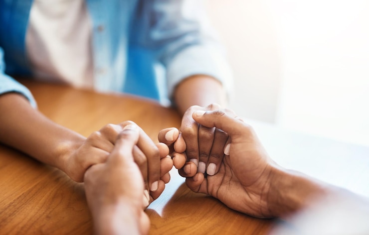 Photo empathy faith and trust with friends and holding hands for comfort kindness and gratitude hope help and support with closeup of people at home for depression during cancer praying or forgiveness