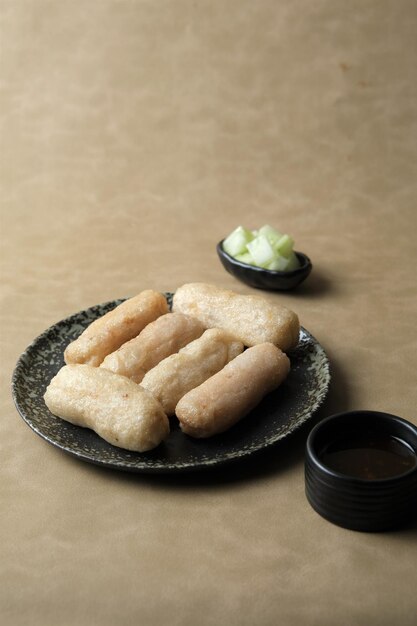 Empek empek or Pempek or Fish Cake on brown background Traditional food from South Sumatera