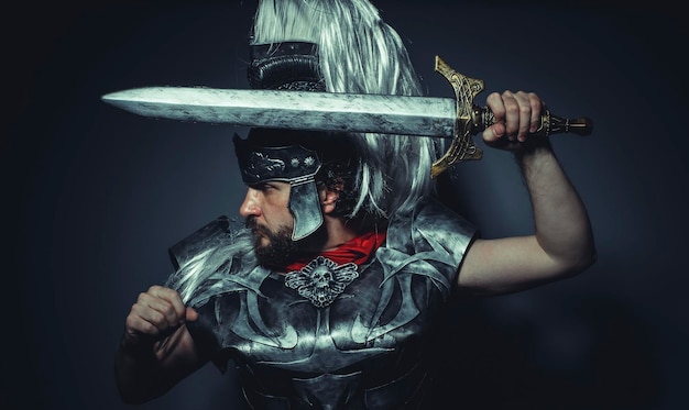 Empire, Roman centurion with armor and helmet with white chalk, steel sword and long red cape