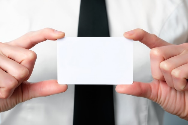 Employee of the bank offers a business card, close up