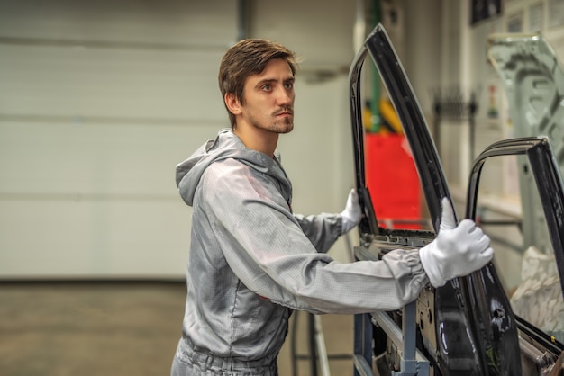 An employee of the body painting workshop checks the quality