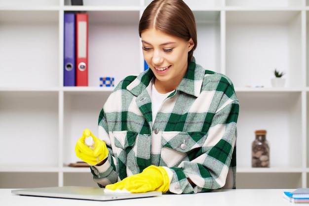 An employee of a cleaning company fulfills orders for office cleaning