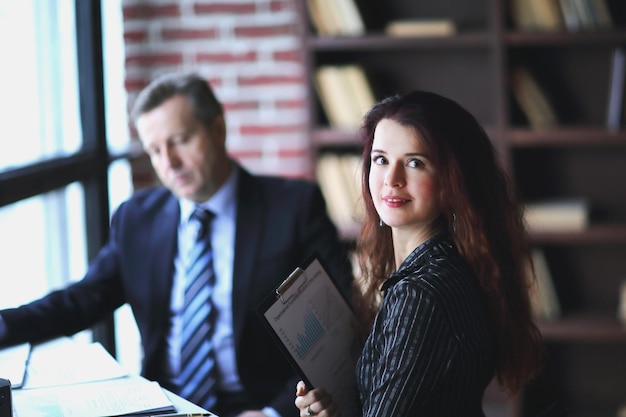 Employee of the company with financial documents in the office