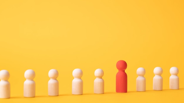 An employee figurine comes out of a row of colleagues Promotion at work appointment to the role of team leader Dismissal of an employee Take the first step be different Initiative and aspiration