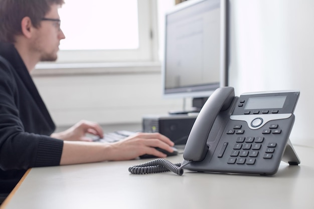 Photo employee is talking on the phone with customers