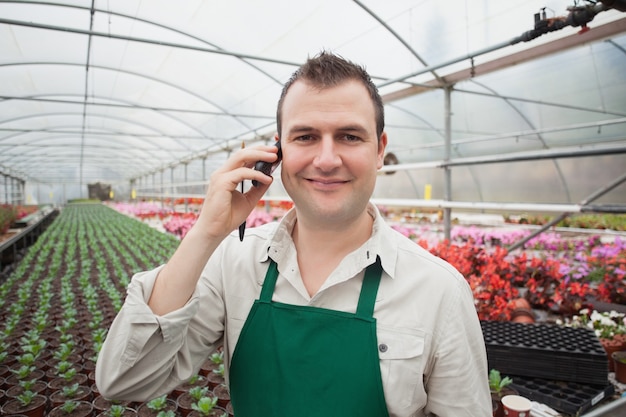 Employee on the phone in greenhouse