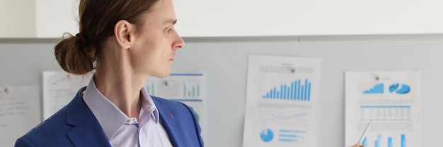 Employee shows infographics on board at meeting in company office worker prepares business