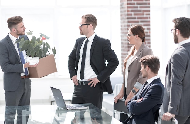 Employee with personal belongings leaving the officethe concept of dismissal