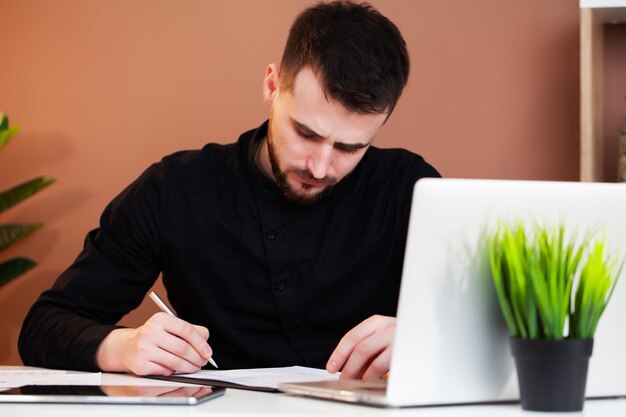 Employee works at the computer in office.