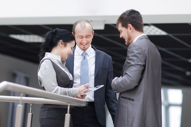 Employees are talking in the lobby of the office